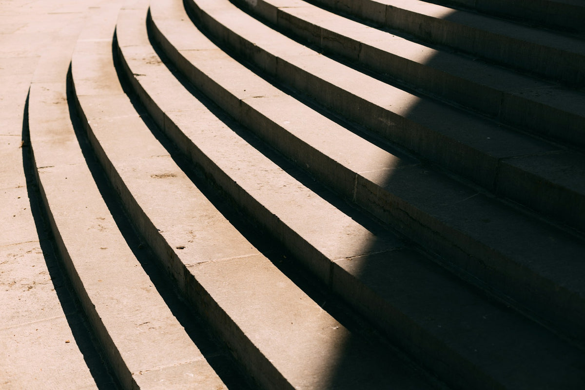 Curved stone steps and diagonal shadows in Tervuren, Belgium. Photograph by Jonas Denil.