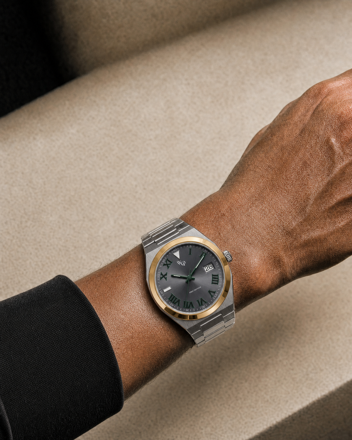 Atria 02 — Steel / Graphite / Gold / Green watch shown on wrist.